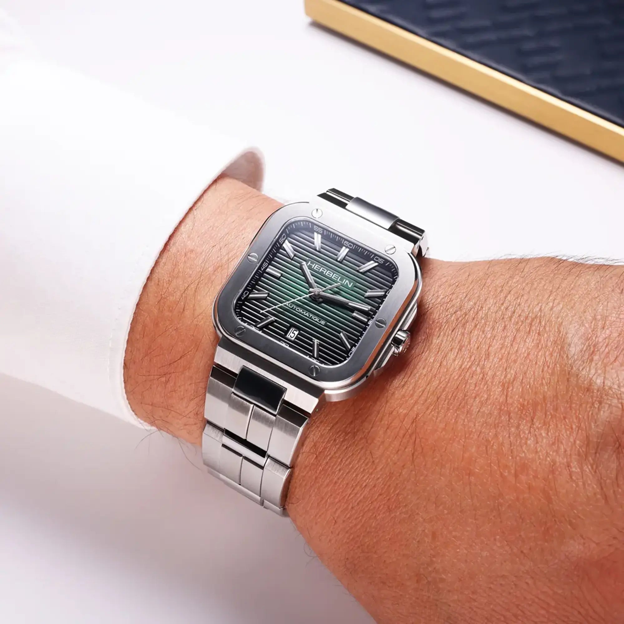 Au poignet masculin, cadran noir et bracelet acier visibles