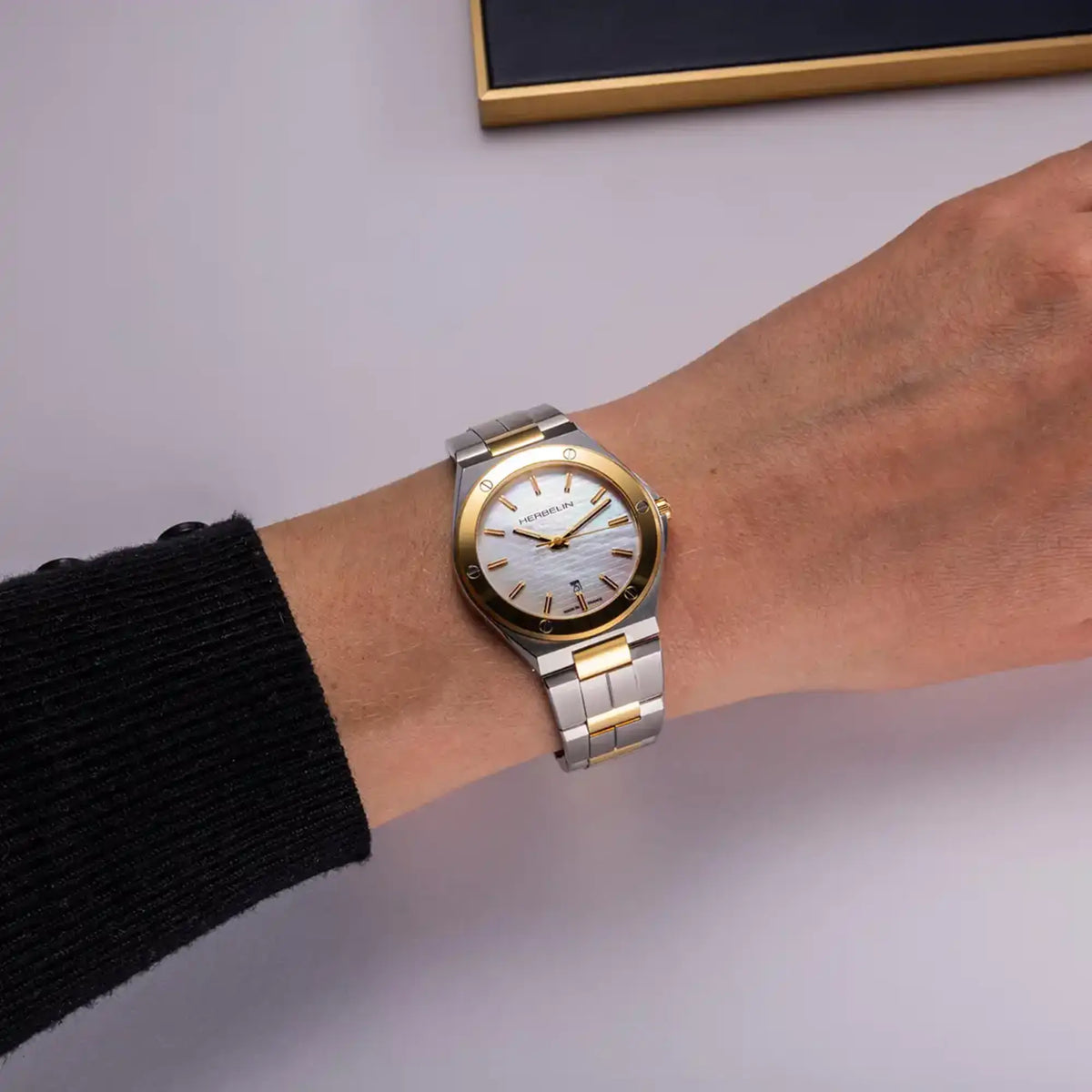 ⁣⁢For the feminine wrist, white mother-of-pearl dial and two-tone steel bracelet visible⁤⁣