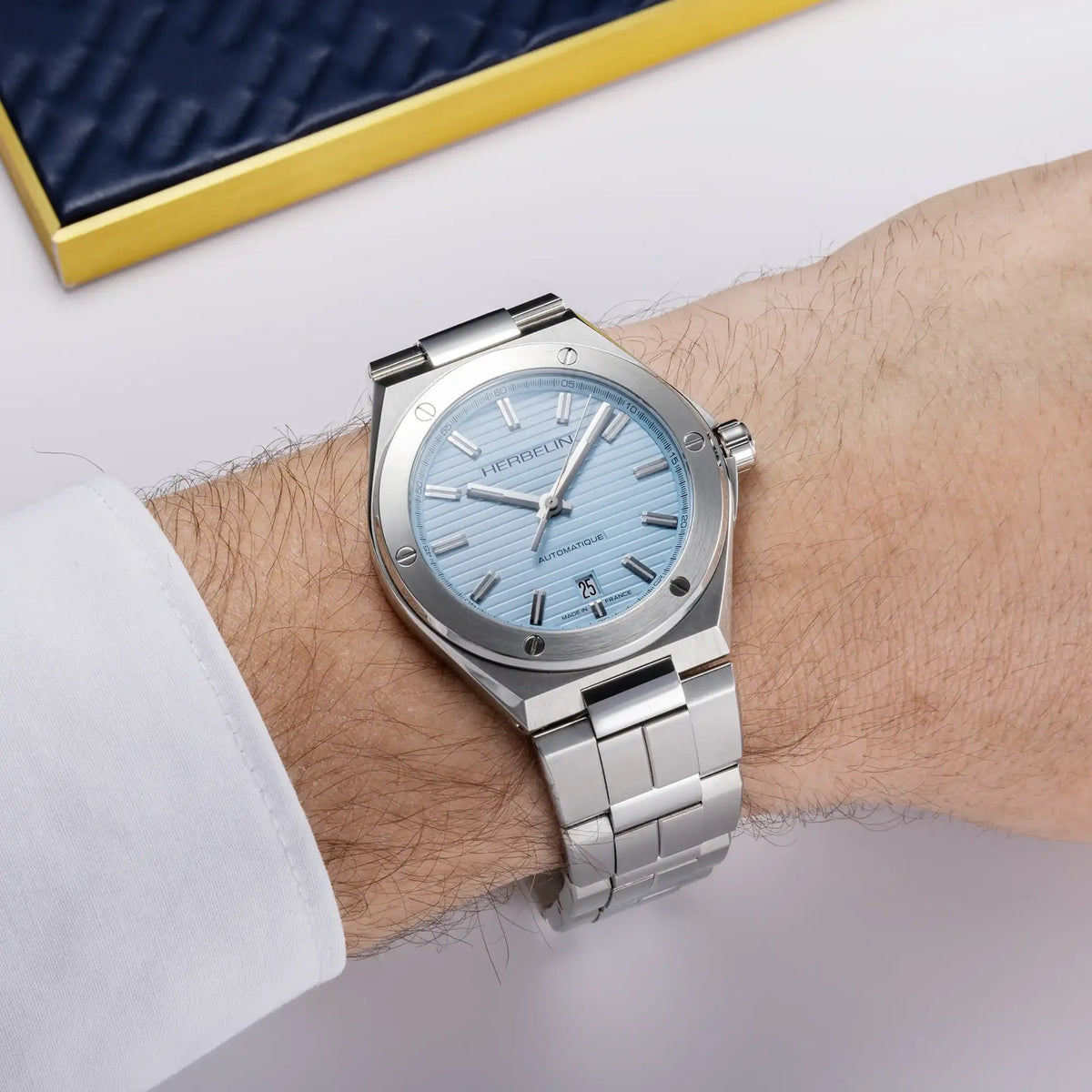⁣⁢On the masculine wrist, an arctic blue dial and steel bracelet are showcased.⁤⁣