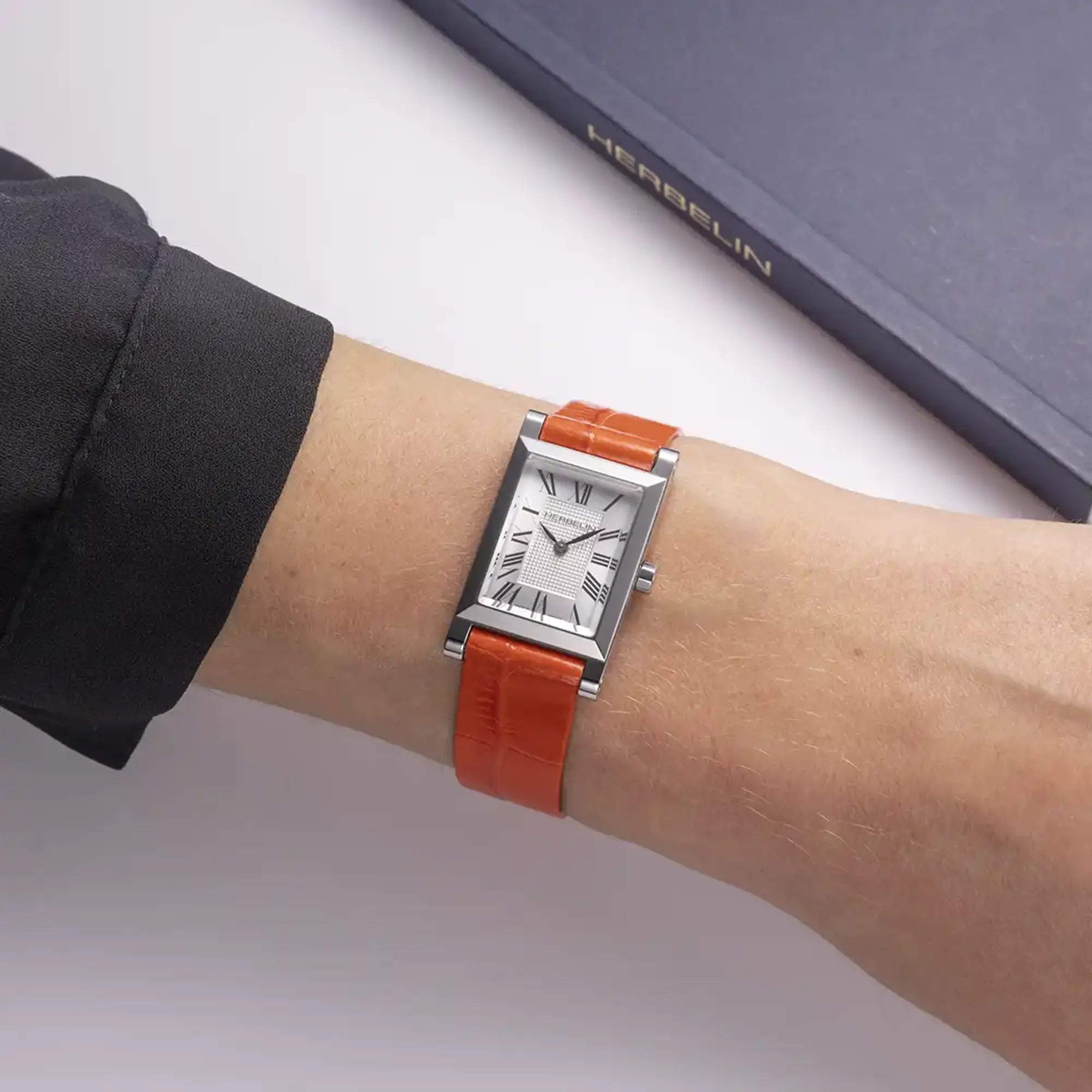 Bracelet porté au poignet féminin, cuir façon croco visible